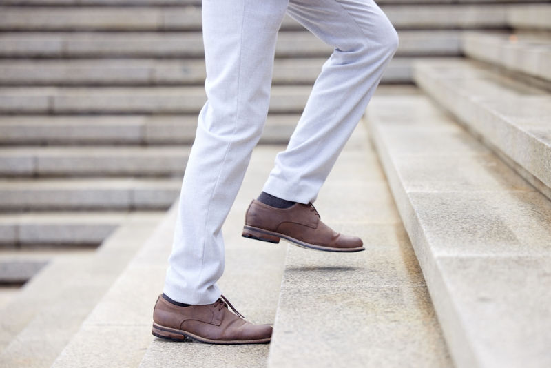 Man climbing stairs representing career growth