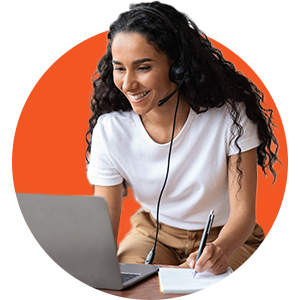 Woman at a computer with a headset on with an orange background