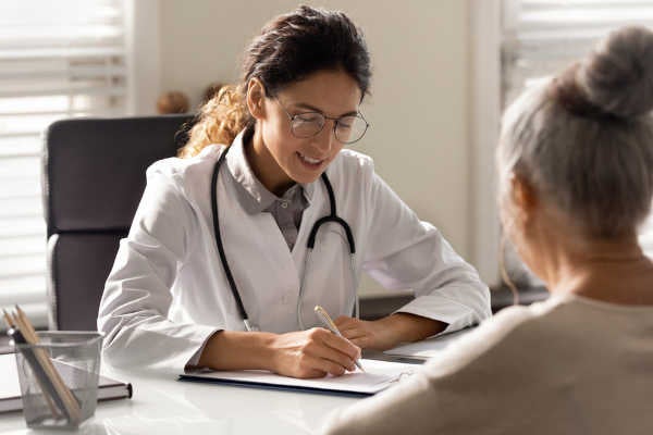 A DNP consulting with her patient