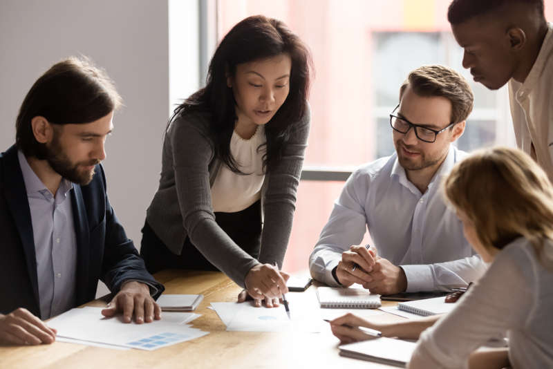 A leader with an Ed.D. working with her team