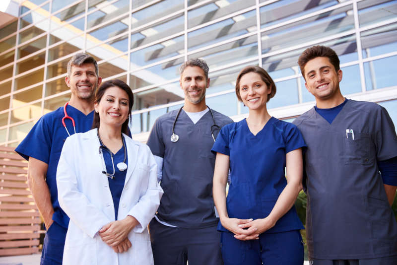 A group of masked nurses and medical professionals.