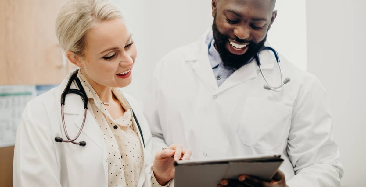 Male nurse and female nurse reviewing patient notes