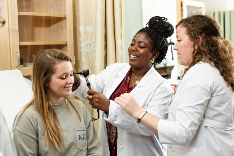 A couple of FNP students at Marymount University performing an exam during residency