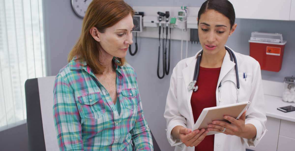a nurse practitioner presenting a diagnosis to her patient