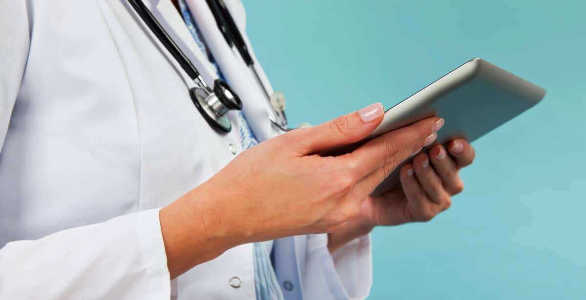 Close-up of female FNP holding a tablet device