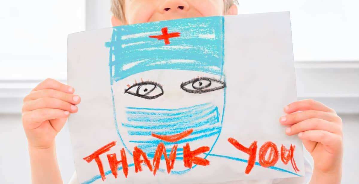 Child holding up thank you sign for nurses