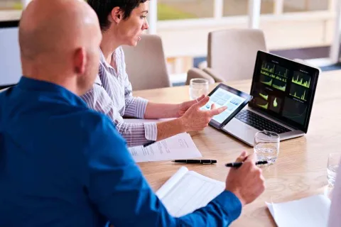 A man and a woman reviewing data in order to make better business decisions