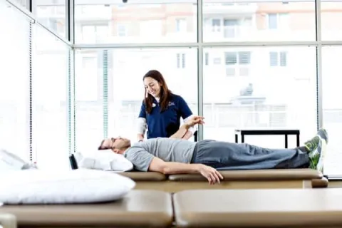 Nurse student examining a male patient