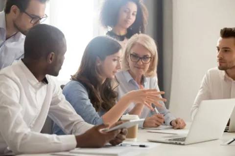 Female boss at technology company leading team meeting