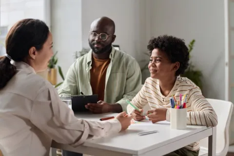 A social worker consulting with a father and their child