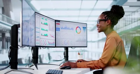BI architect reviewing multiple BI dashboards