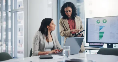 Two women working on a BI dashboard