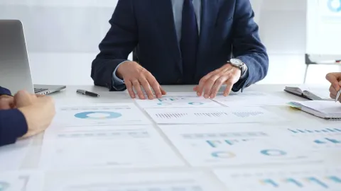 Executive working at desk reviewing reports