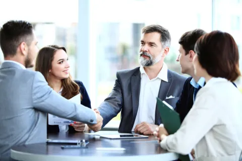 A business leader shaking hands with another stakeholder